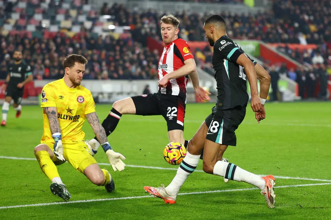 Liverpool's Ryan Gravenberch (right) attacking against Brentford's Mark Flekken (left) and Nathan Collins on Jan 18.