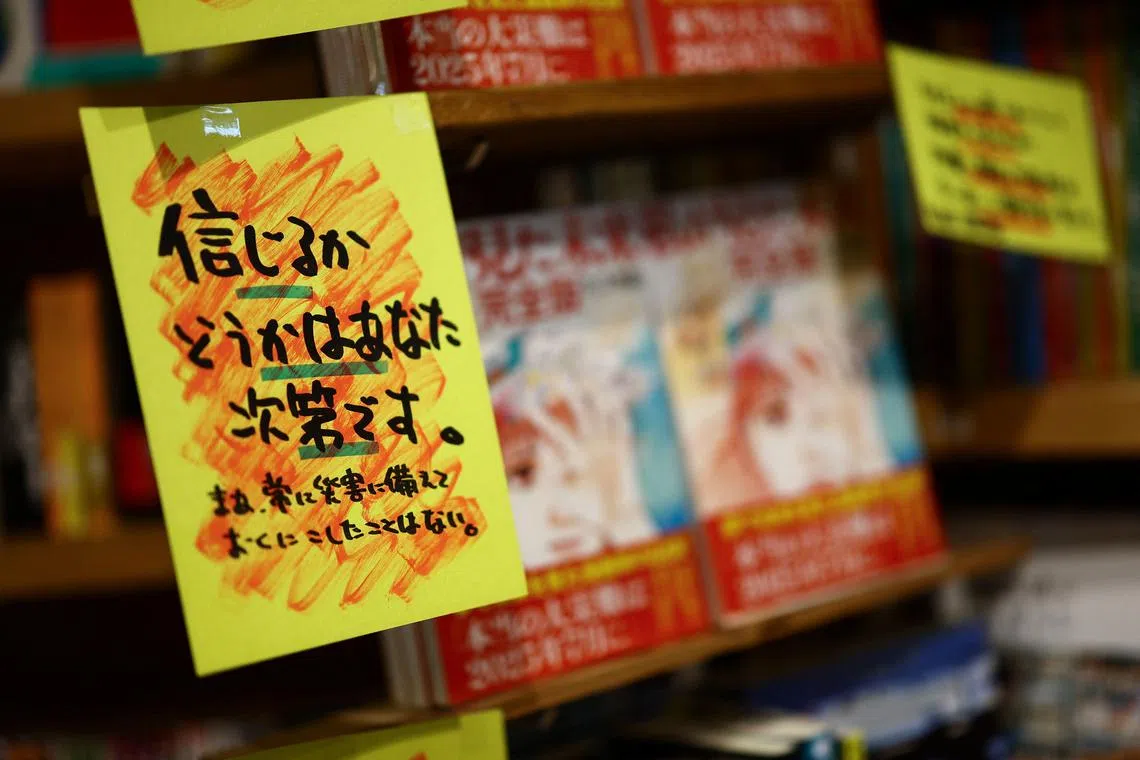A sales banner written by the store reading 'Whether you believe it or not is up to you' is displayed next to the comic book titled 'The Future I saw', authored by manga artist Ryo Tatsuki, on the shelf at the book store Village Vanguard in Tokyo, Japan June 30, 2025. REUTERS/Issei Kato