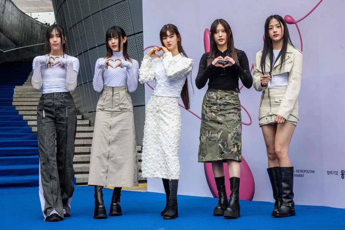 Members of South Korean K-pop group NewJeans pose on the blue carpet at Seoul Fashion Week at Dongdaemun Design Plaza in Seoul on March 15, 2023. 