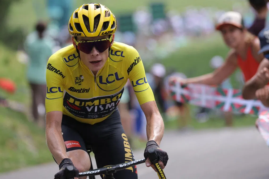 Jonas Vingegaard, wearing the overall leader's yellow jersey, cycles the final kilometres of the Tour's 17th stage.