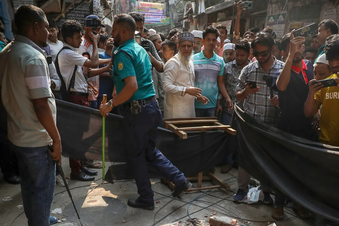 Locals rushing out into the streets after an eight-story building's railing collapsed during an earthquake in Dhaka, Bangladesh, on Nov 21.
