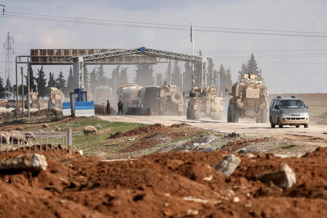 U.S. military vehicles escort buses transporting Islamic State detainees from Syria to Iraq, according to a security source from the Syrian Democratic Forces, in Qamishli, Syria, February 8, 2026. REUTERS/Orhan Qereman