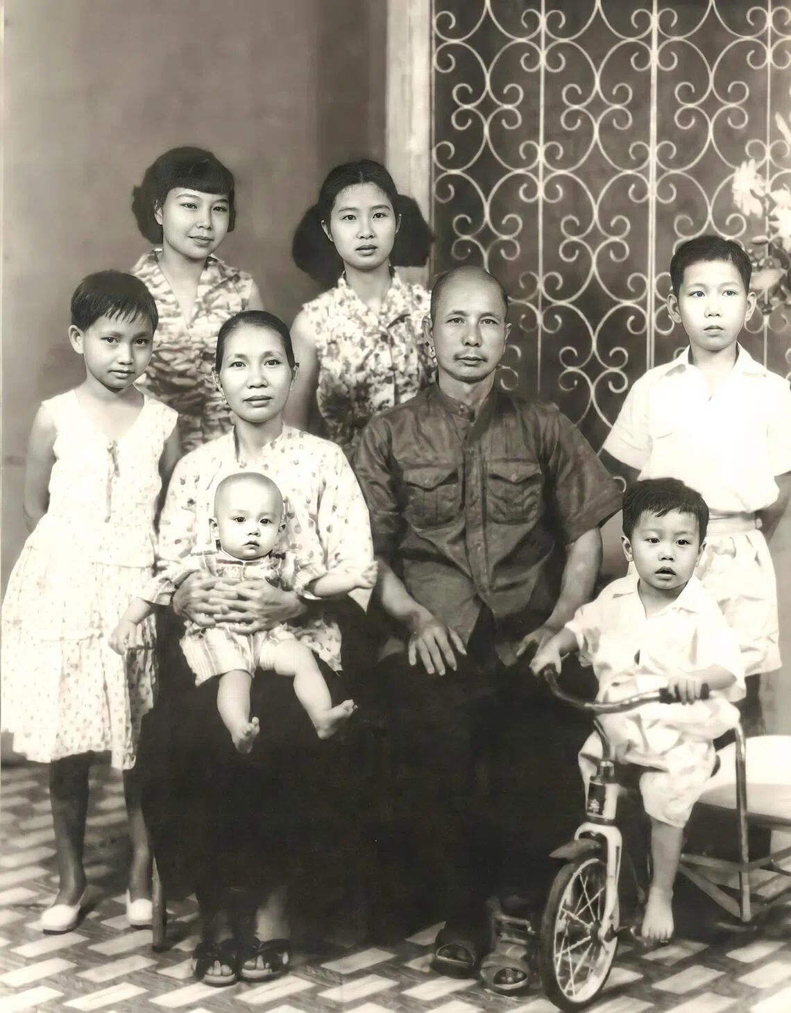 A one-year-old Sim Wong Hoo is seen here being cradled by his mother, Tan Seok Kee, in 1956.