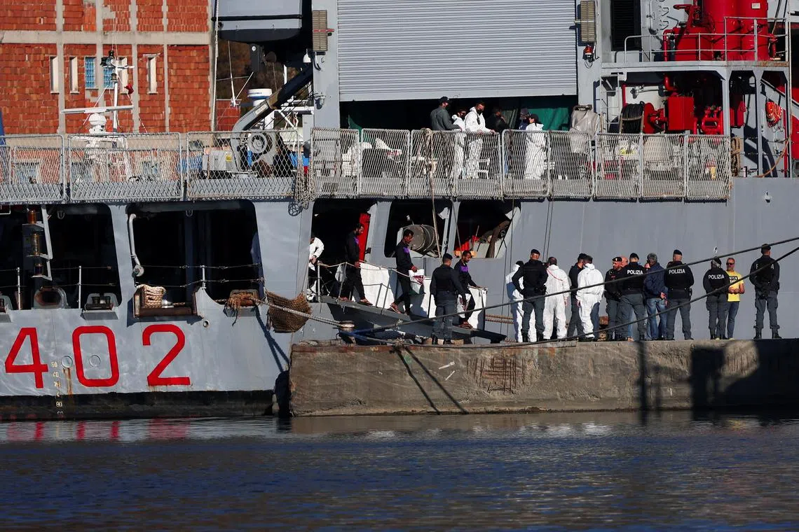 FILE PHOTO: Migrants disembark from the Italian navy ship Libra carrying migrants that arrived in Albania as part of a deal with Italy to process thousands of asylum-seekers caught near Italian waters, in Shengjin, Albania, November 8, 2024. REUTERS/Florion Goga/File Photo