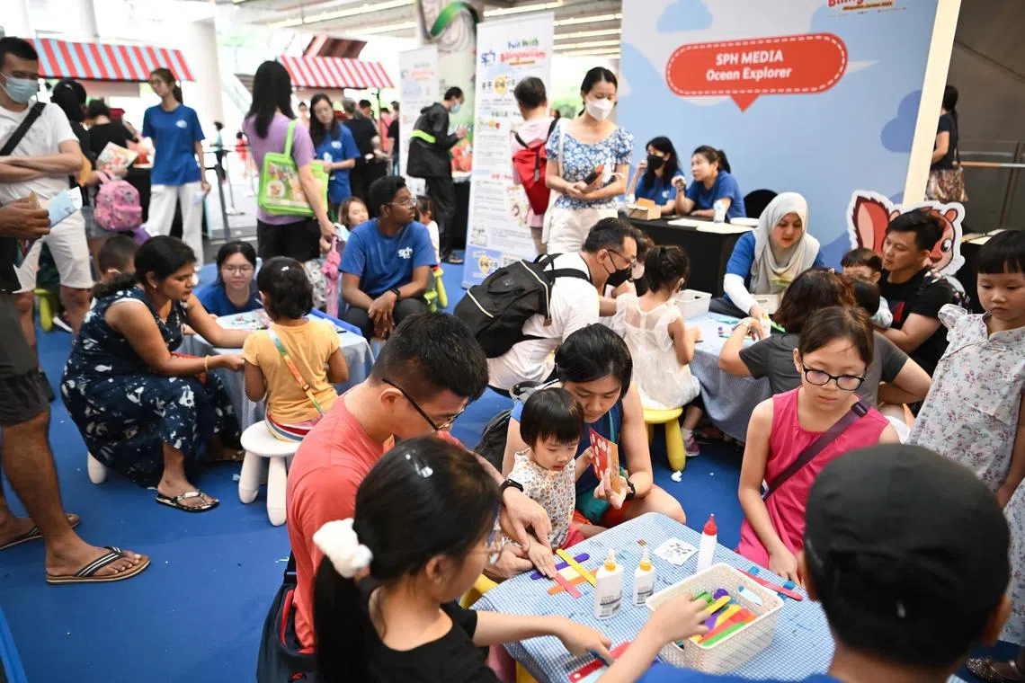 People at the activity booth during the inaugural Bilingualism Carnival at One Punggol on Apr 8, 2023.
The event was supported by the Lee Kuan Yew Fund for Bilingualism. 
(ST PHOTO: LIM YAOHUI)
