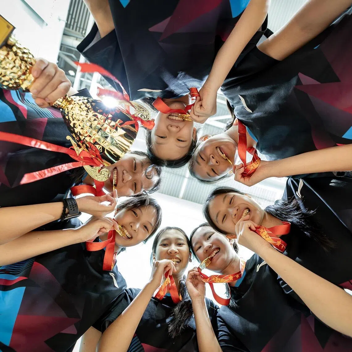 Nanyang Girls’ High School celebrating their National B Division Girls’s Badminton win against Raffles Girls’ School.



