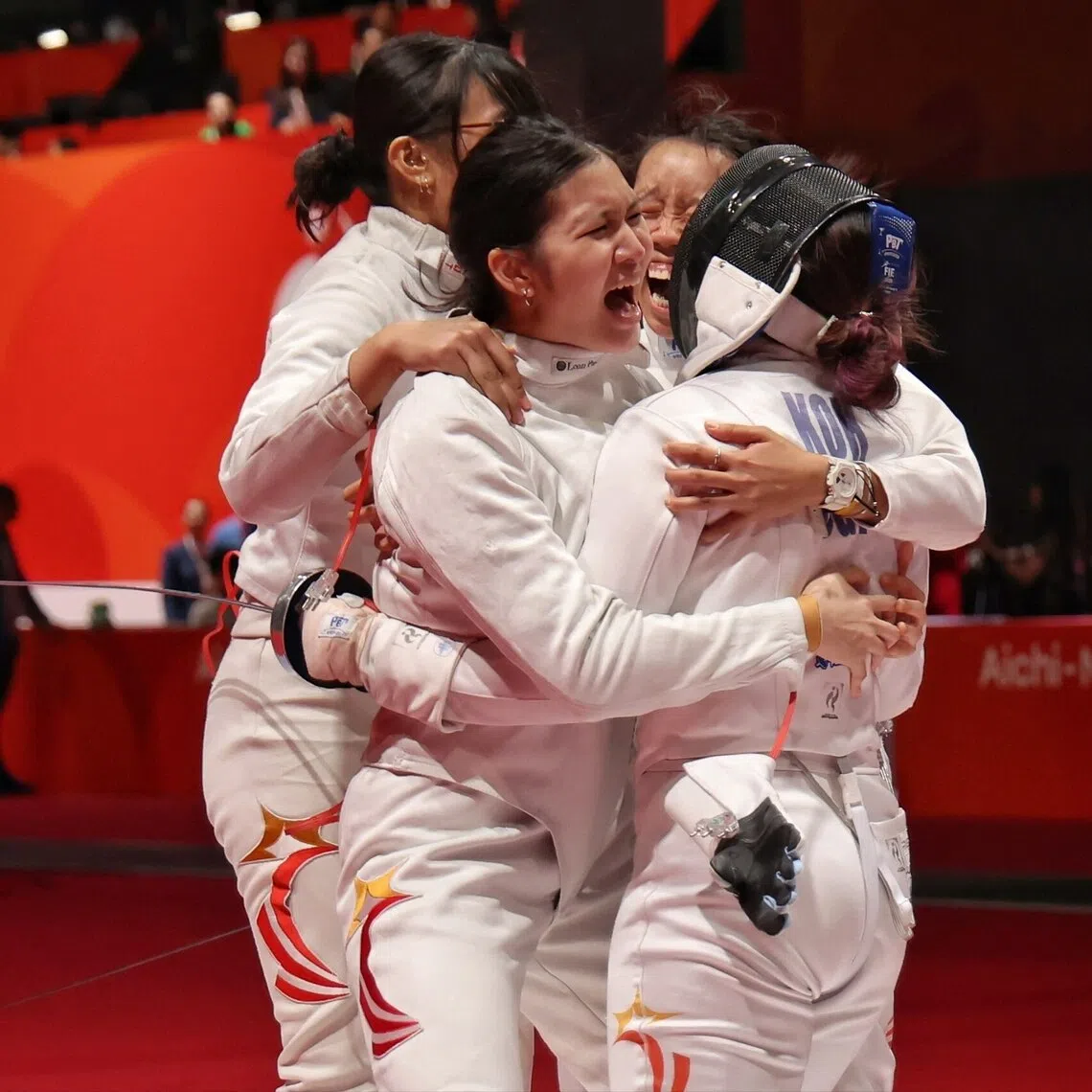 Elle Koh (right) of Singapore getting mobbed by her teammates after securing a 42-41 win.