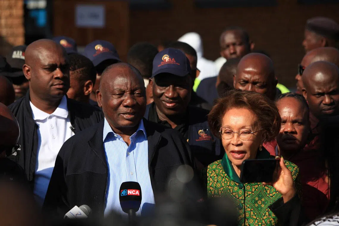 South African president Cyril Ramaphosa, accompanied by his wife Tshepo Motsepe, speaks to the media after casting his vote during the South African elections in Soweto, South Africa May 29, 2024. REUTERS/Oupa Nkosi
