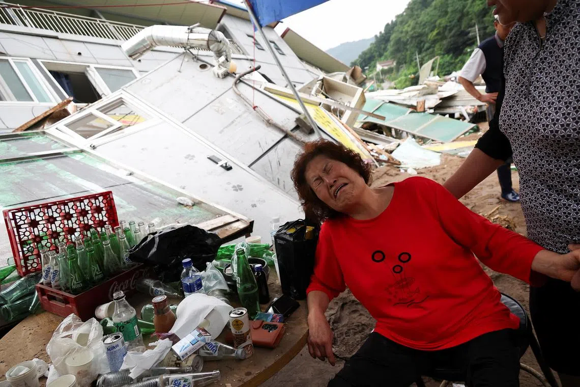 Ms Ahn Gyeong-Bun, 65, cries amid the ruins of a restaurant she had operated for a decade.