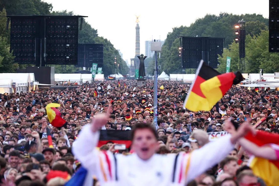 FILE PHOTO: Soccer Football - Euro 2024 - Fans in Berlin gather at a fan zone to watch Germany v Scotland - Brandenburg Gate, Berlin, Germany - June 14, 2024 General view of Germany fans in the fan park ahead of the match REUTERS/Liesa Johannssen/File Photo