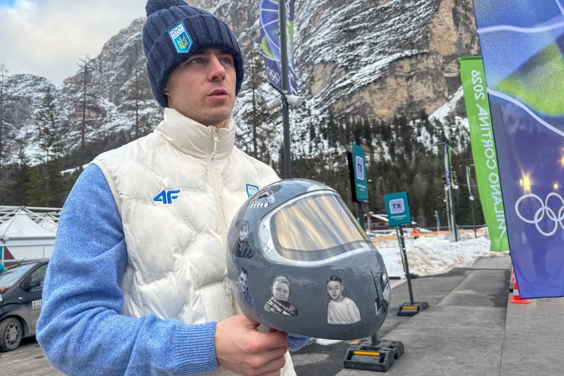 Ukrainian skeleton athlete Vladyslav Heraskevych holds his helmet with images of compatriots killed during the war in Ukraine, at the Milano Cortina Gamesin in Cortina D'Ampezzo, Italy, February 9, 2026. REUTERS/Cristiano Corvino