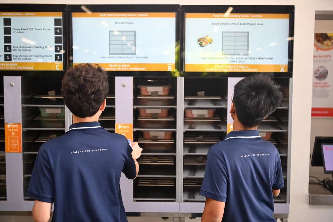 Yusof Ishak Secondary School students taking meals from the meal dispensers during recess on Sept 3.