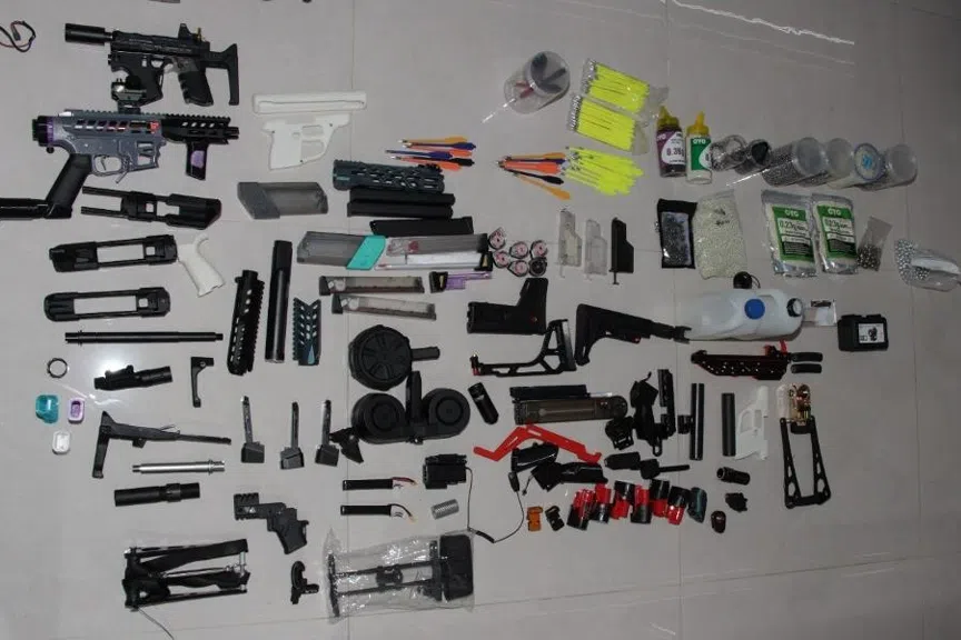 During the investigation, officers discovered a substantial cache of weapons and prohibited items in the unit.