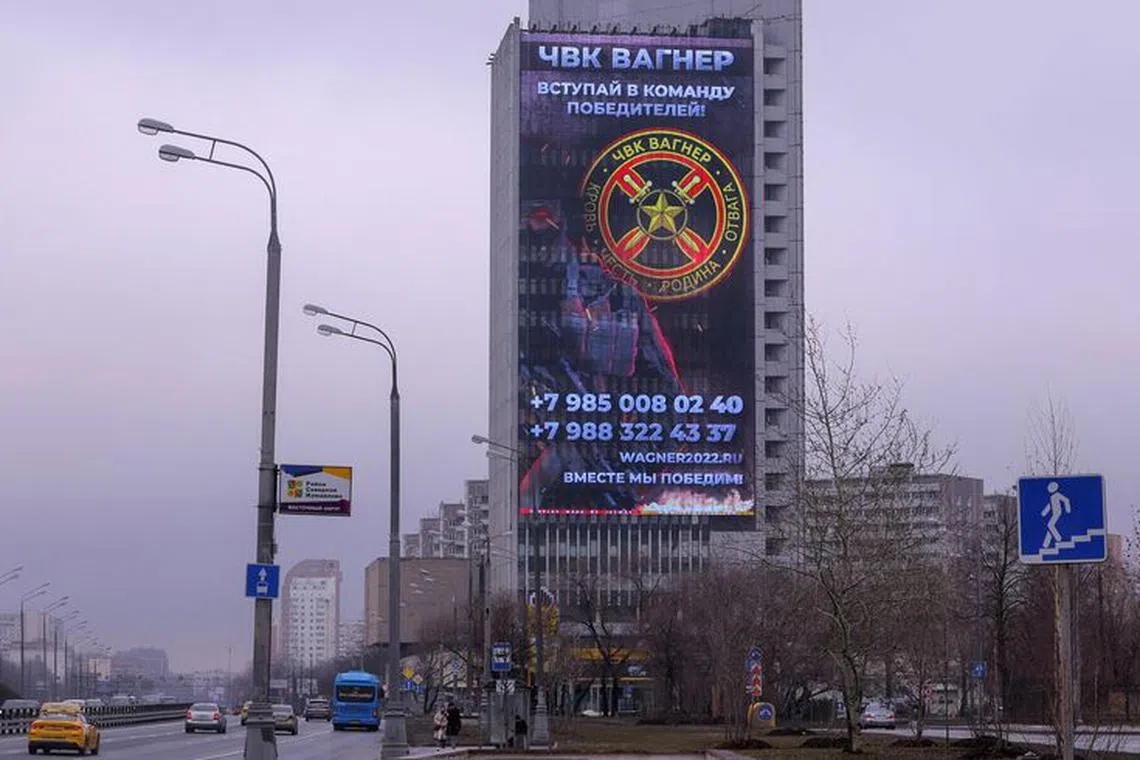FILE PHOTO: An advertising screen, which promotes to join Wagner private mercenary group, is on display on the facade of a building in Moscow, Russia, March 27, 2023. REUTERS/Evgenia Novozhenina/File Photo