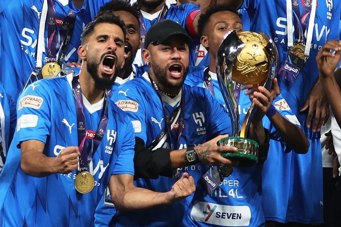 FILE PHOTO: Soccer Football - Saudi Super Cup - Final - Al Hilal v Al Ittihad - Mohammed Bin Zayed Stadium, Abu Dhabi, United Arab Emirates - April 11, 2024 Al Hilal's Neymar lifts the trophy with teammates after winning the Saudi Super Cup final REUTERS/Stringer/File Photo