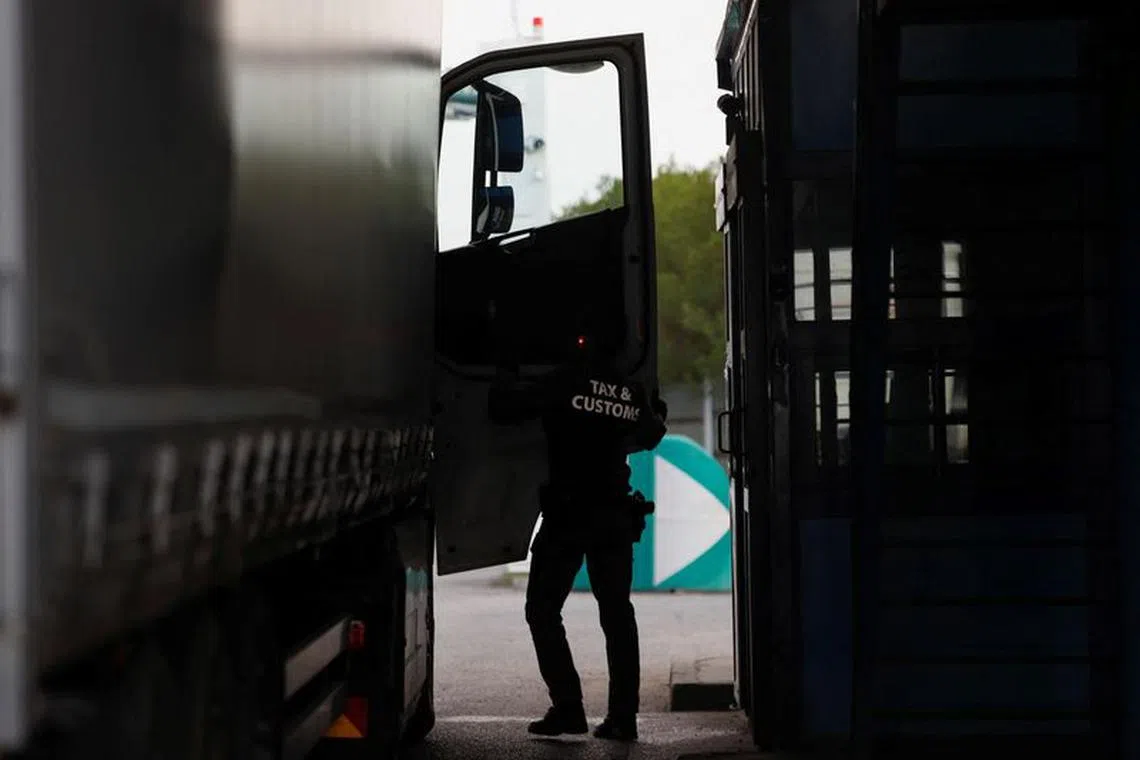 A member of the Tax and Customs Directorate checks an Ukrainian truck at the Hungarian-Ukrainian border, in Zahony, Hungary, April 19, 2023. REUTERS/Bernadett Szabo/File Photo