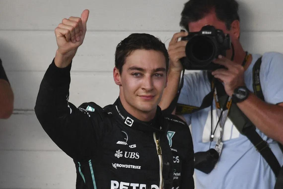 Mercedes' British driver George Russell celebrates after winning the sprint qualifying to obtain the pole position.
