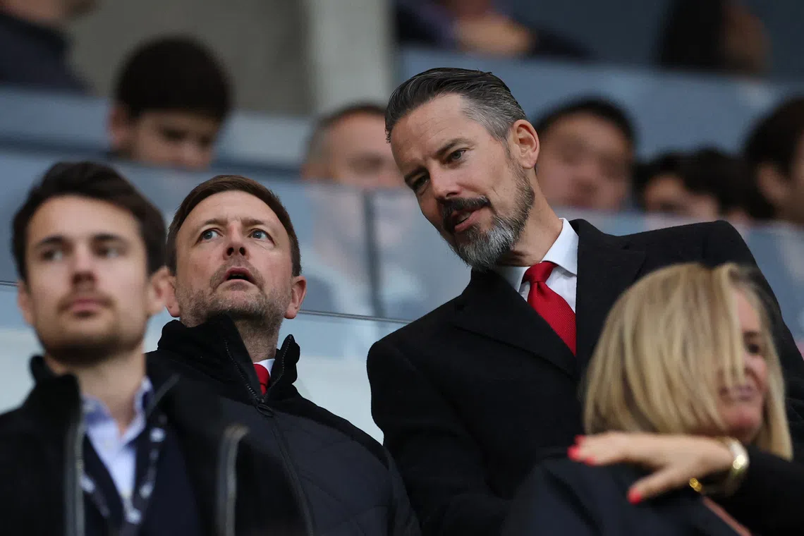 Arsenal CEO Richard Garlick (second from left) and co-chair Josh Kroenke (right) in the stands before an English Premier League match.