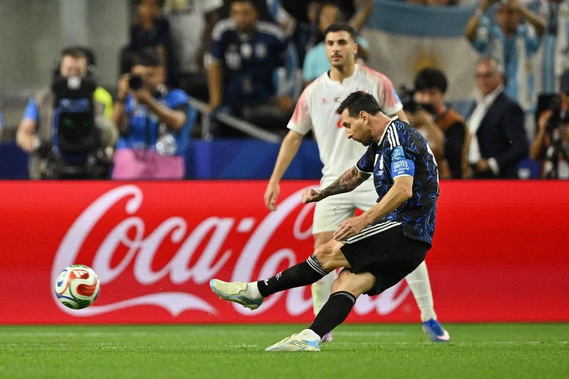Argentina’s Lionel Messi scores their third goal from a free kick.