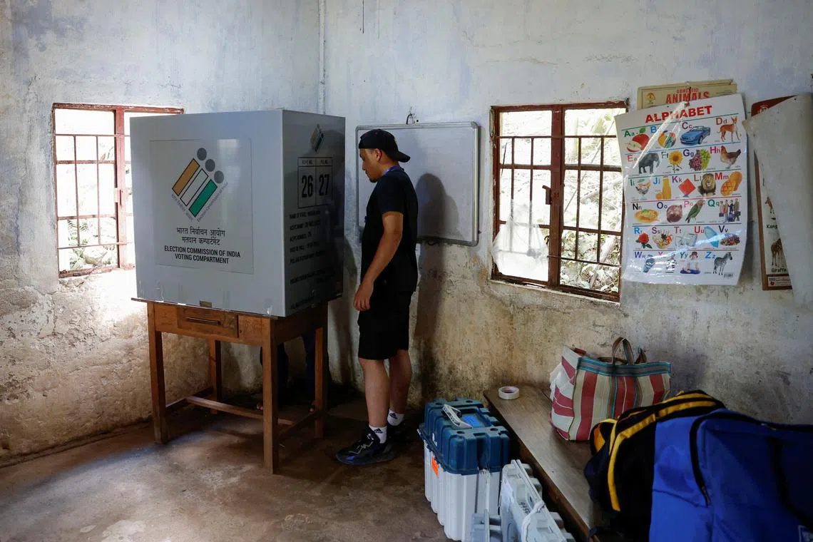 Polling officer Stevenson M. Khonglah, sets up the polling booth in Nongriat village, the location of a remote polling station, on the eve of the first phase of the election, in Shillong in the northeastern state of Meghalaya, India, April 18, 2024. REUTERS/Adnan Abidi