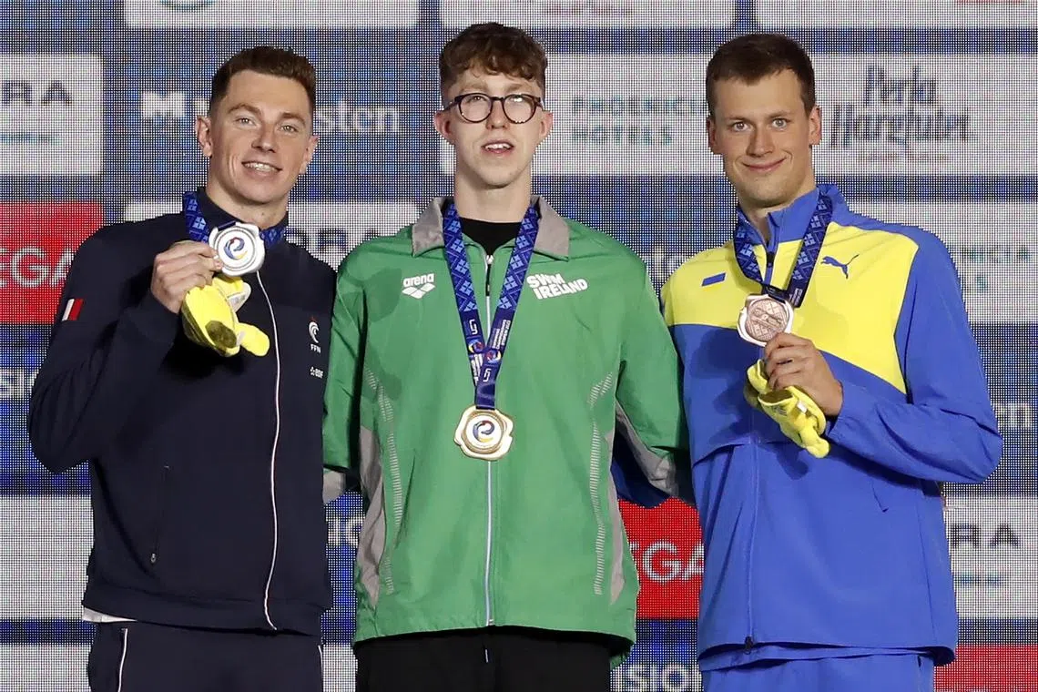 Ukraine's Mykhailo Romanchuk (right) after taking third place in the men's 1500m freestyle final at the European Short Course Championships, in Otopeni, Romania, with second-placed David Aubry of France (left), and winner Daniel Wiffen of Ireland.