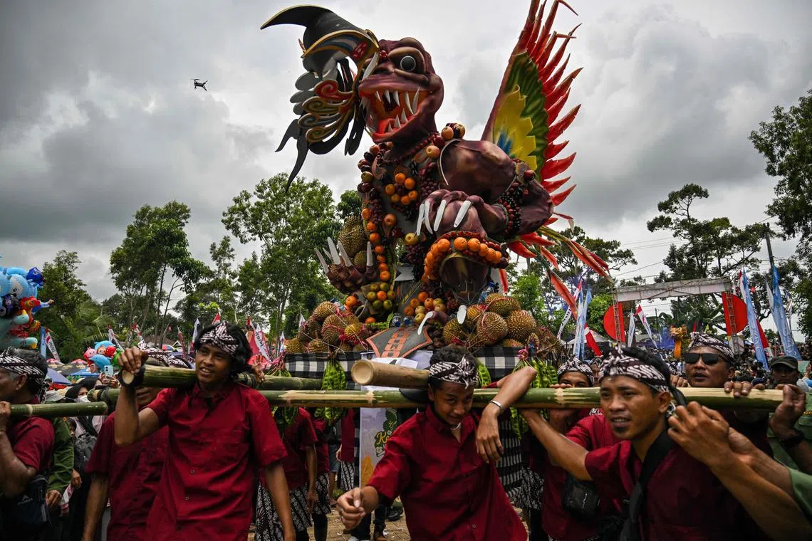 Villagers parading a float of durian and other fruits during the Durian Festival 'Kenduren Wonosalam' in Wonosalam village, East Java, Indonesia, on Feb 23, 2025.