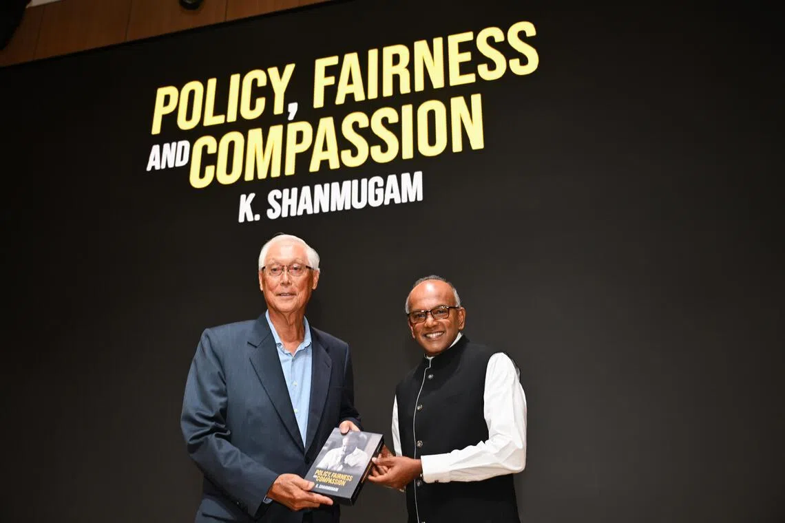 Coordinating Minister for National Security and Minister for Home Affairs K Shanmugam presenting his book Policy, Fairness and Compassion to ESM Goh Chok Tong at the book launch on Feb 6. 