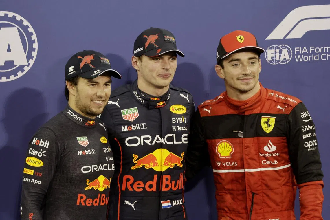 Red Bull's Max Verstappen celebrating after qualifying in pole position for the F1 Abu Dhabi Grand Prix at Yas Marina Circuit on Nov 19, 2022, with teammate Sergio Perez second and Ferrari's Charles Leclerc third.