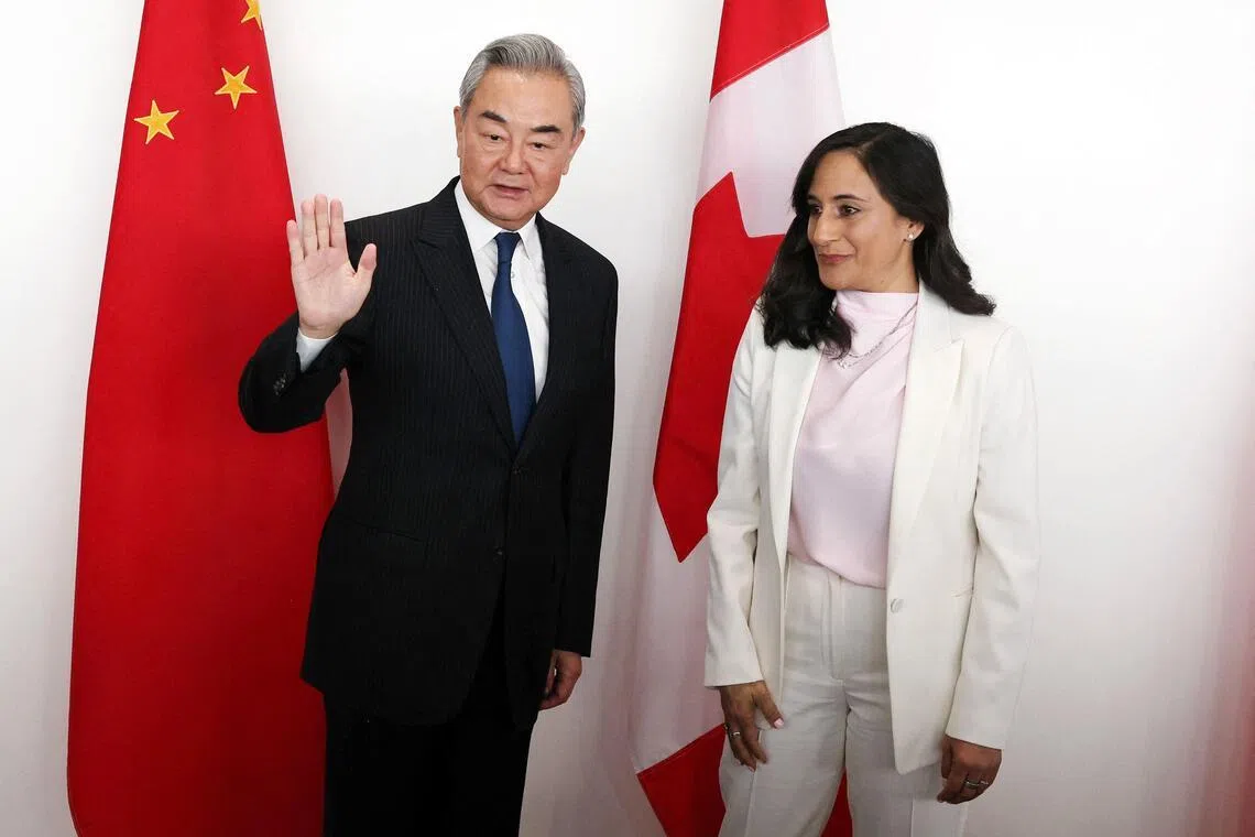 Canadian Foreign Minister Anita Anand (right) and Chinese Foreign Affairs Minister Wang Yi posing for a photo ahead of a bilateral meeting in Ottawa, on May 29.
