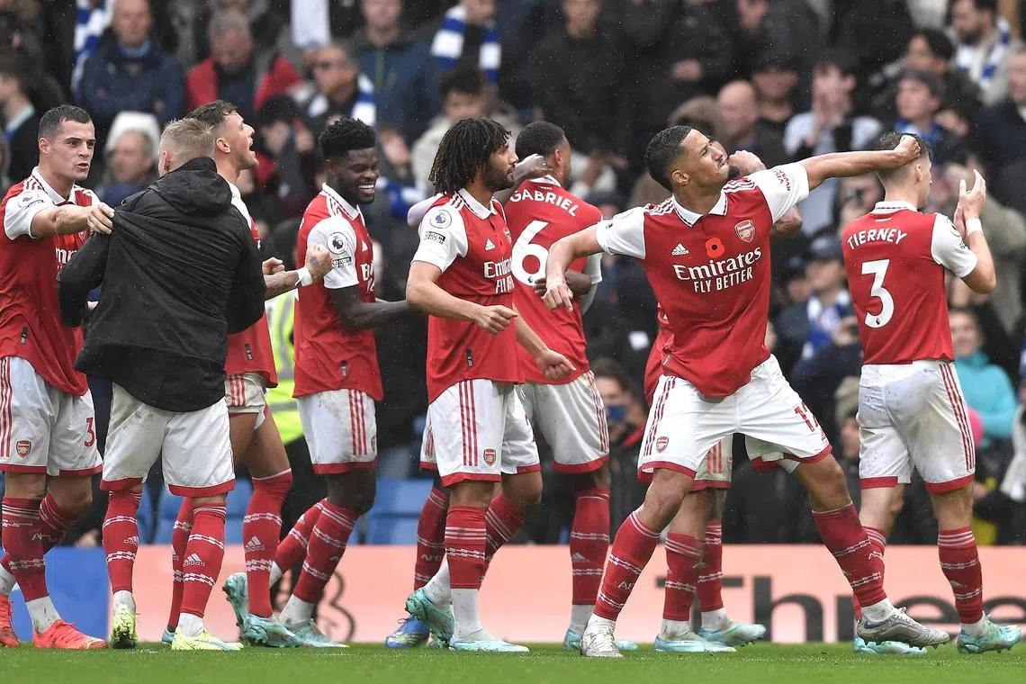 Arsenal players celebrating after winning the English Premier League match away to Chelsea in London on Sunday.