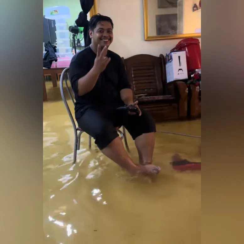 The 11-sec clip showed a man sitting on a chair and surrounded by ankle-deep murky water. 