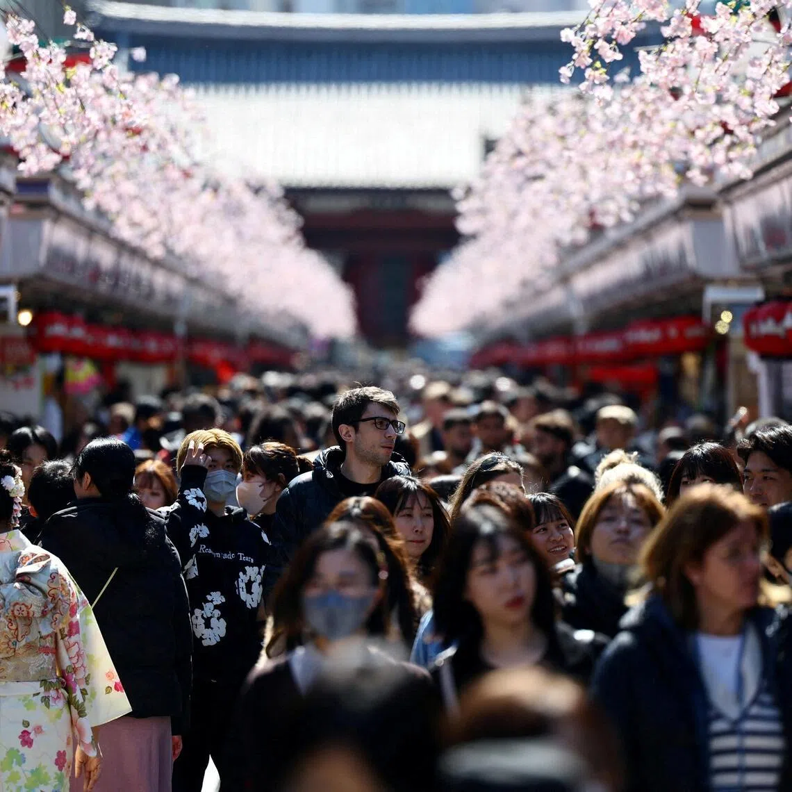 Visitors walk along Nakamise-dori street as they visit Sensoji temple at Asakusa district, in Tokyo, Japan on March 10, 2025.