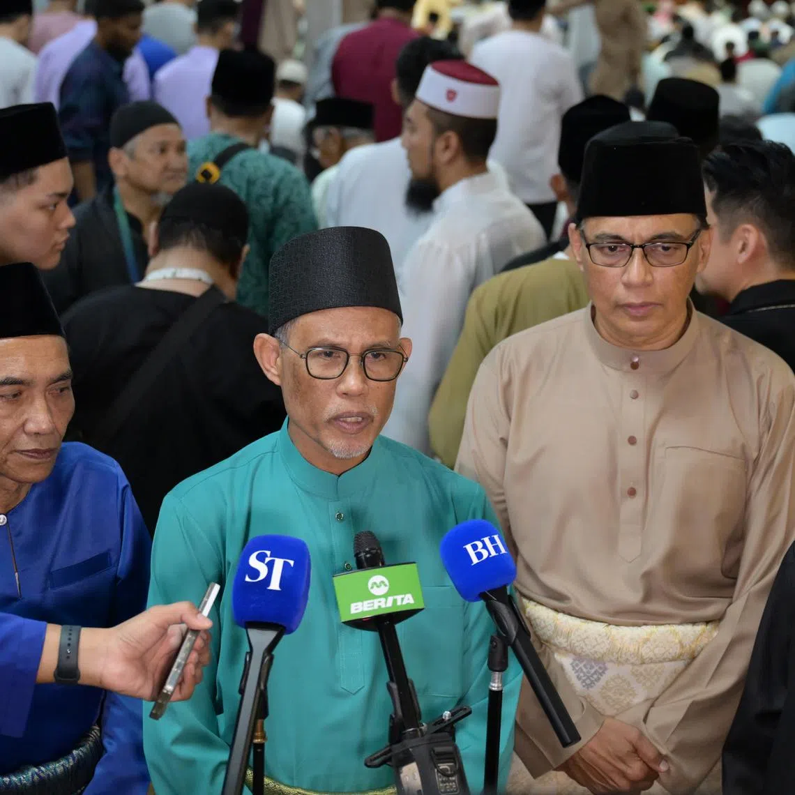 Minister for Social and Family Development Masagos Zulkifli (centre) speaking to the media at Masjid Al-Iman on March 31.