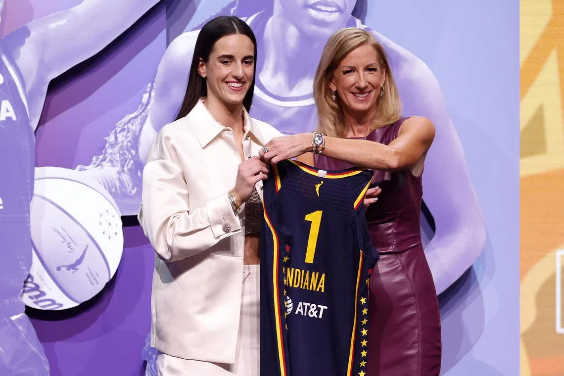 Caitlin Clark poses with WNBA commissioner Cathy Engelbert after being selected first overall pick by the Indiana Fever during the 2024 WNBA Draft.