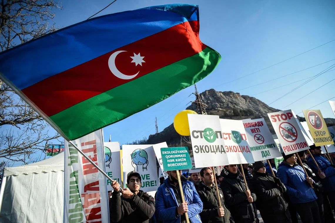 Azerbaijani protesters along a road linking Nagorno-Karabakh to Armenia claim to oppose illegal mining in the area. 