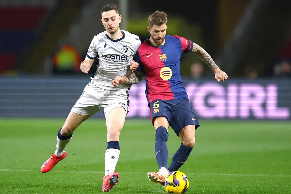 FILE PHOTO: Soccer Football - LaLiga - FC Barcelona v Osasuna - Estadi Olimpic Lluis Companys, Barcelona, Spain - March 27, 2025 FC Barcelona's Inigo Martinez in action with Osasuna's Raul Garcia REUTERS/Albert Gea/File Photo