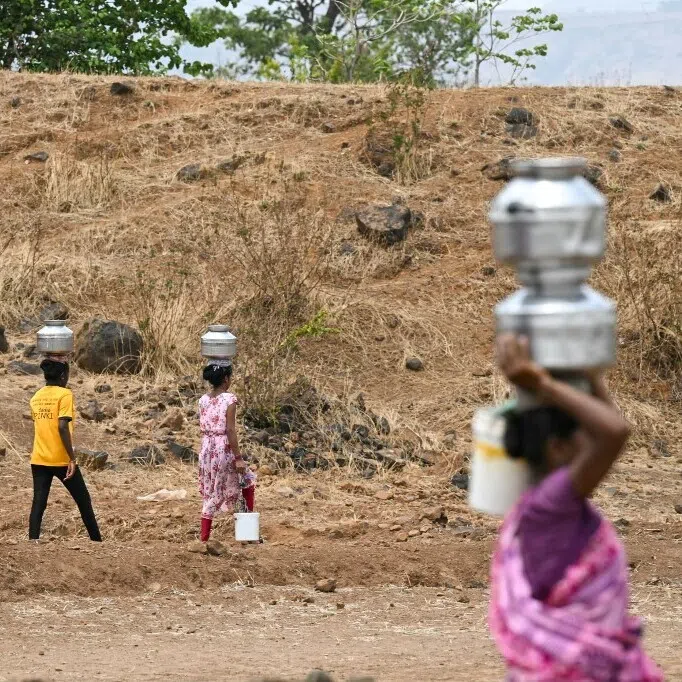 In this photo taken on May 26, 2024, villagers carry water pots in Shahapur district of India's Maharashtra state, amid ongoing heatwave.