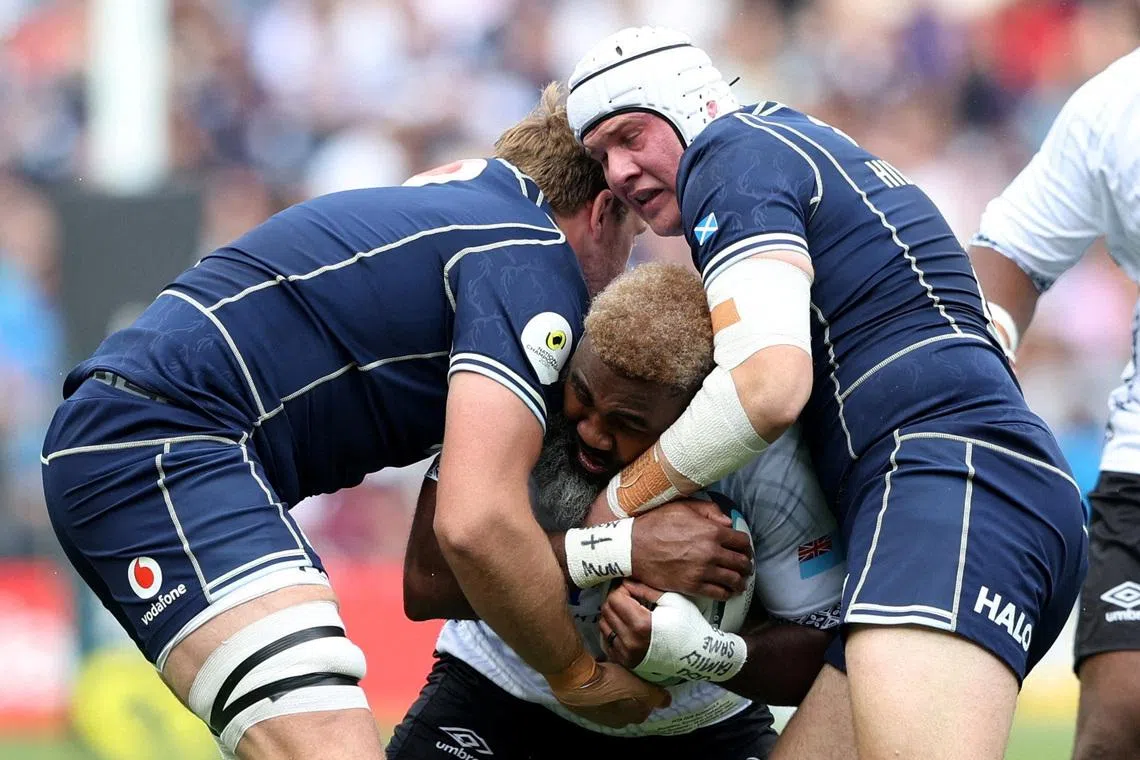 Rugby Union - Nations Championship - Fiji v Scotland - Murrayfield Stadium, Edinburgh, Scotland, Britain - July 18, 2026 Fiji's Pita Gus Sowakula in action with Scotland's Gregor Hiddleston and Jonny Gray REUTERS/Scott Heppell