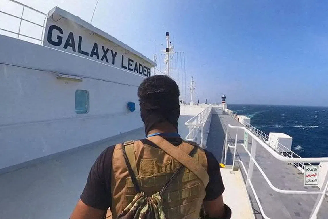 FILE PHOTO: A Houthi fighter stands on the Galaxy Leader cargo ship in the Red Sea in this photo released November 20, 2023. Houthi Military Media/Handout via REUTERS/File Photo