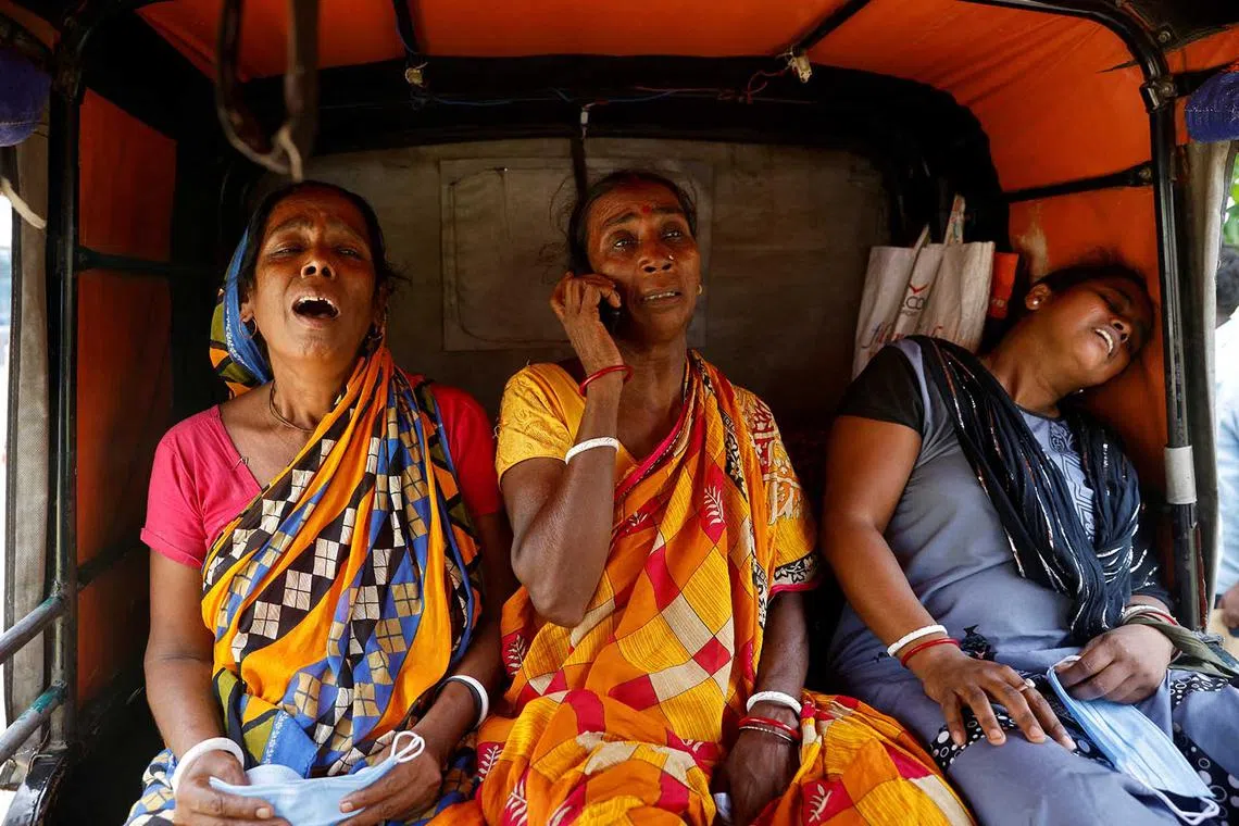 Relatives of train collision victims react as they sit in an autorickshaw outside a temporary mortuary created in a business park, following the train collision in Balasore district in the eastern state of Odisha, India, June 4.