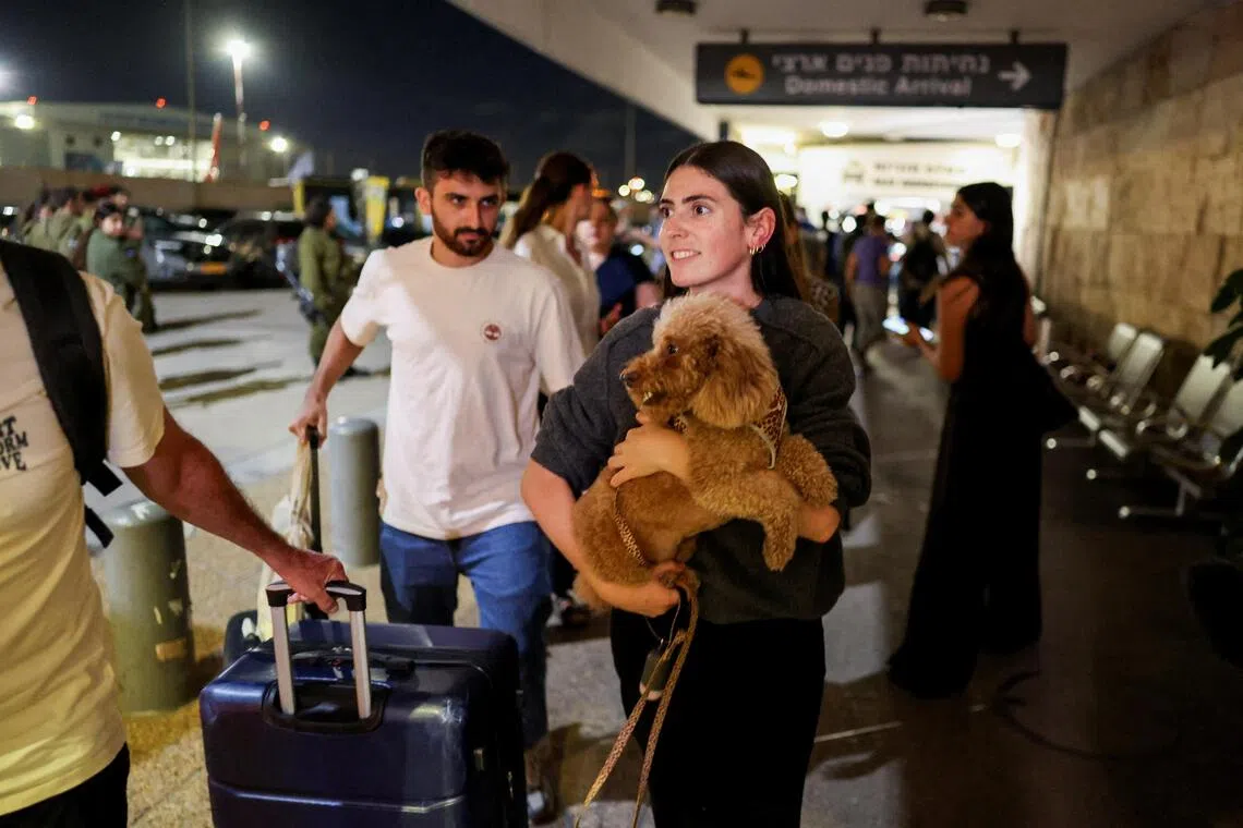 Passengers from flydubai flight FZ1073 arriving back in Israel on Sept 30. A pilot was reportedly stabbed by his co-worker who Israel accused of trying to crash the plane.