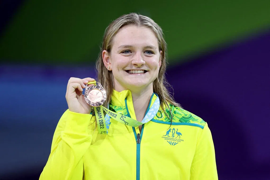 FILE PHOTO: Commonwealth Games - Swimming - Women's 100m Breaststroke - Medal Ceremony - Sandwell Aquatics Centre, Birmingham, Britain - August 2, 2022 Bronze medallist Australia's Chelsea Hodges celebrates on the podium during the medal ceremony REUTERS/Stoyan Nenov/File Photo