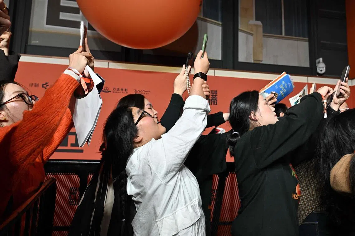 Chinese fans gather as Timothee Chalamet (unseen) arrives on the red carpet for screening of his film Marty Supreme in Beijing on March 10.