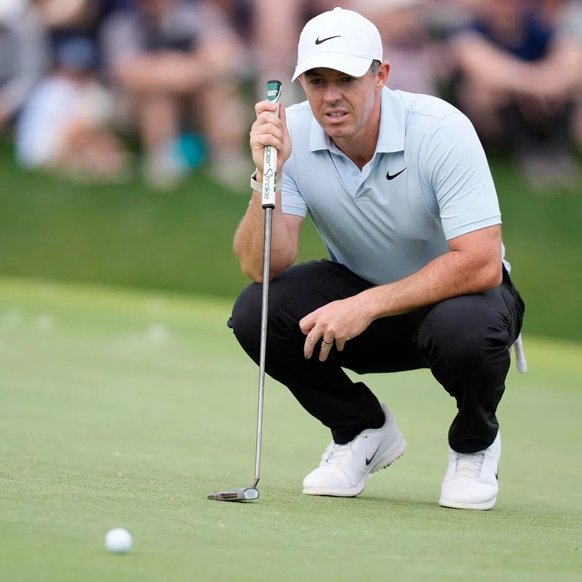 Rory McIlroy eyes his line on 18 during the second round of the Truist Championship.