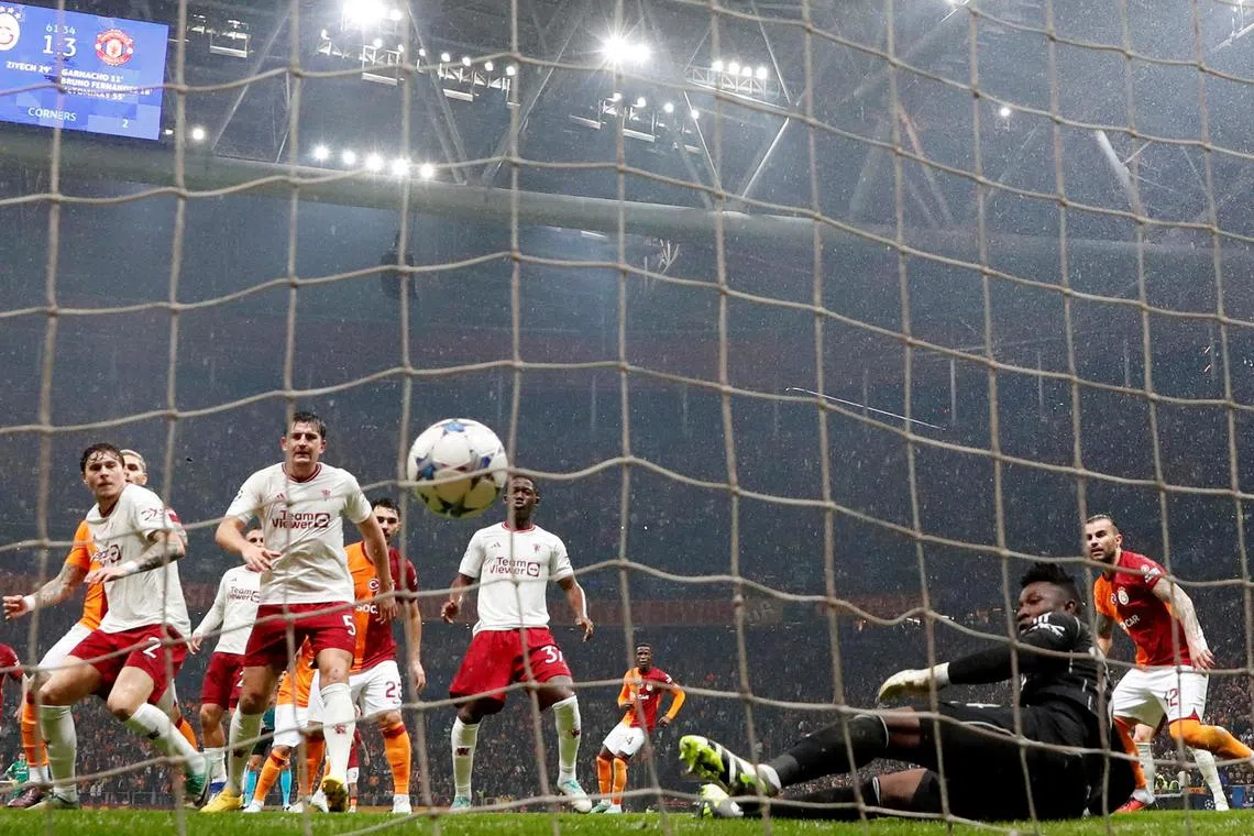 Galatasaray's Hakim Ziyech scores their second goal past Manchester United's Andre Onana. 