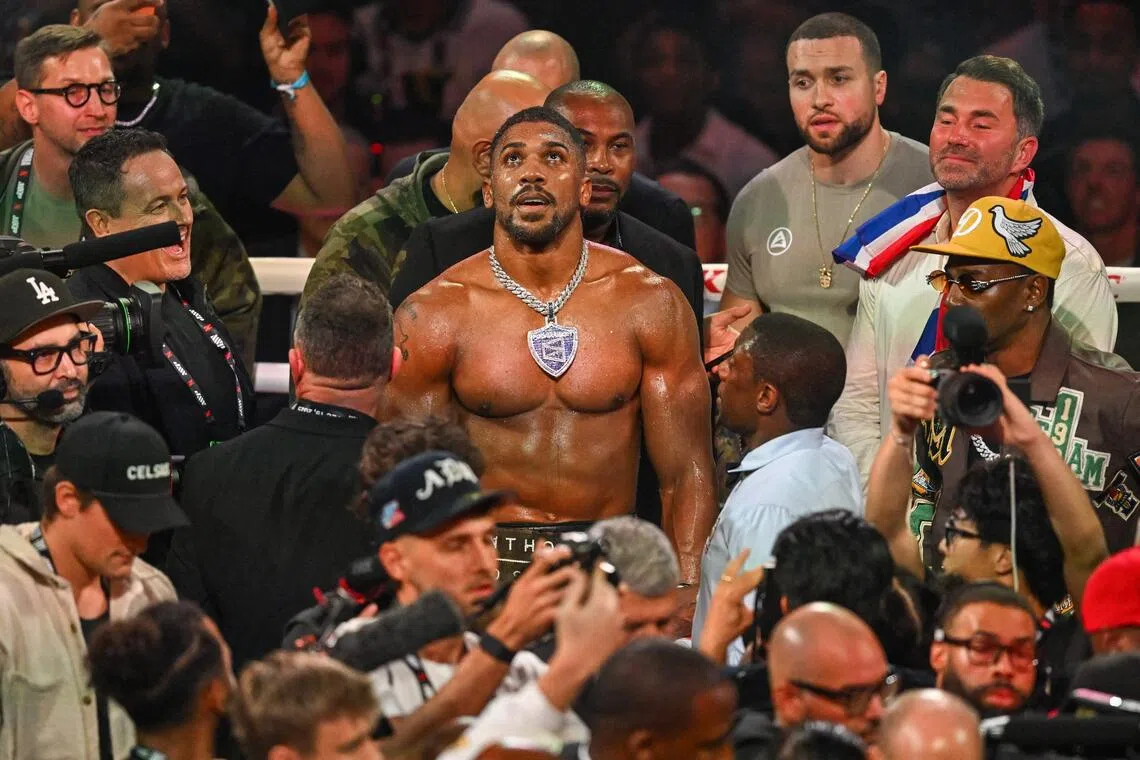 British boxer Anthony Joshua celebrates after defeating US boxer and influencer Jake Paul (off frame) in a non-title heavyweight bout at the Kaseya Center in Miami.
