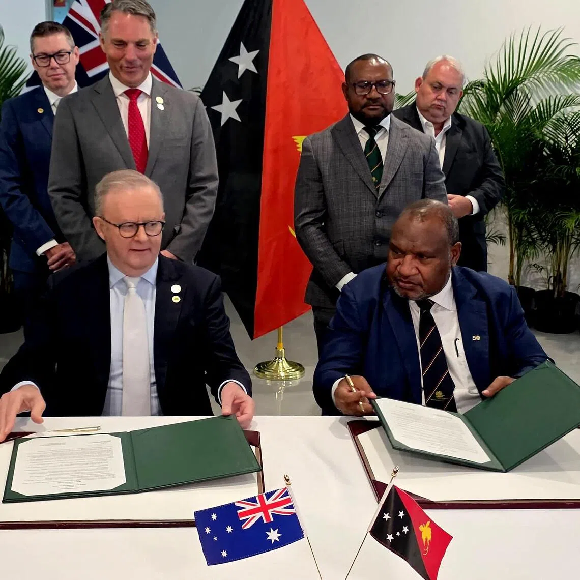 Papua New Guinea's Prime Minister James Marape (R) and his Australian counterpart Anthony Albanese sign a mutual communique in Port Moresby on September 17, 2025. Australia and Papua New Guinea failed to sign a long-awaited mutual defence treaty as expected on September 17, as Canberra seeks to deepen ties with Pacific nations and counter Beijing's rising influence. (Photo by AFP)