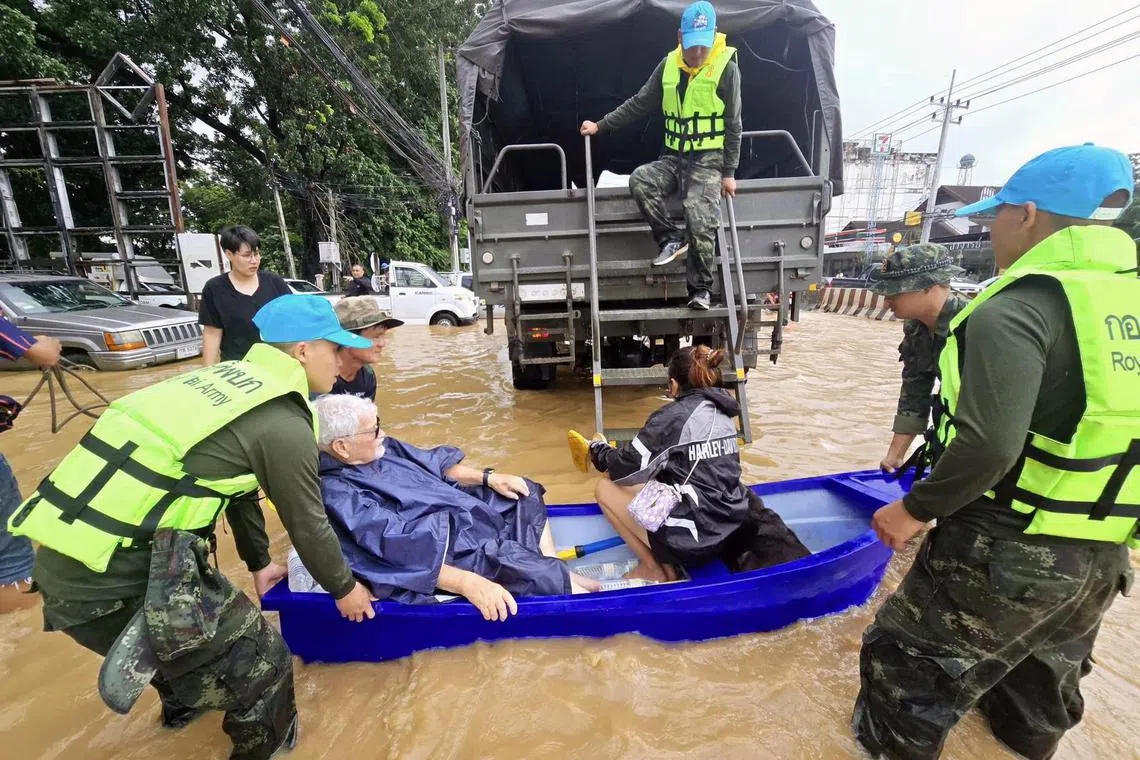 Thai soldiers evacuate residents from their flooded houses in the tourist city of Chiang Mai, northern Thailand, on Sept 26, 2024.