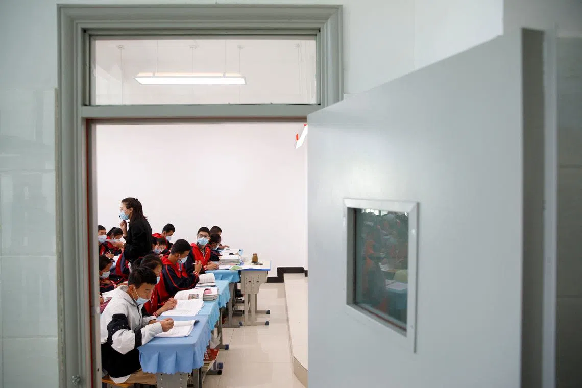FILE PHOTO: Students attend a class at Duilongdeqing District high school in Lhasa, during a government-organised tour of the Tibet Autonomous Region, China, October 16, 2020. Picture taken October 16, 2020. REUTERS/Thomas Peter/File Photo