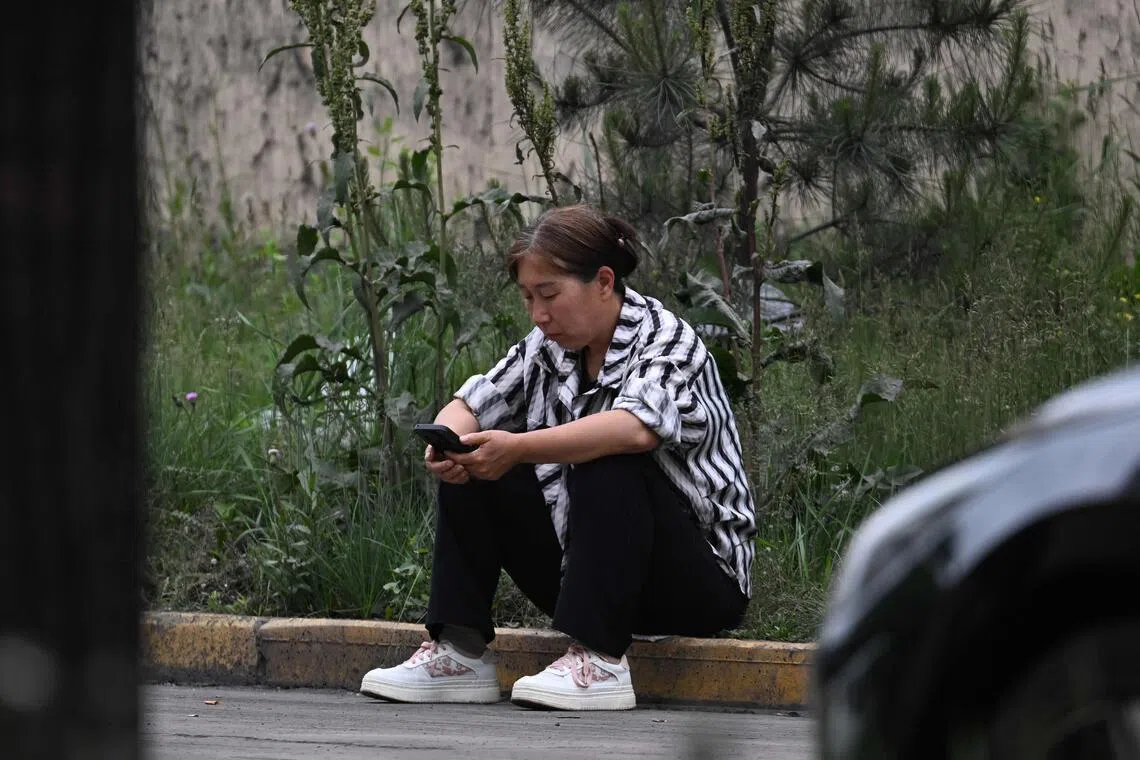 A relative of a missing miner waits for news outside the Liushenyu coal mine, where an explosion killed dozens.
